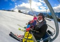 Family riding ski lift cable car on winter vacation skiing Royalty Free Stock Photo